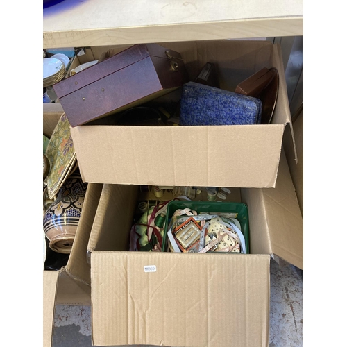 889 - Nine boxes containing pictures, table lamps, cutlery, sewing items, glassware, dolls, teddy bears an... 