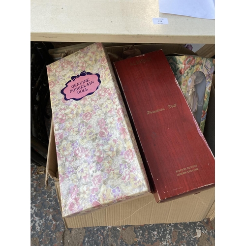 889 - Nine boxes containing pictures, table lamps, cutlery, sewing items, glassware, dolls, teddy bears an... 