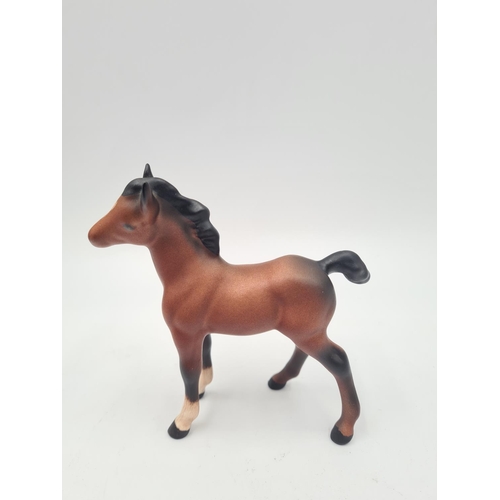 201 - Three Beswick figurines, two foals and one Shetland pony - largest approx. 12cm high