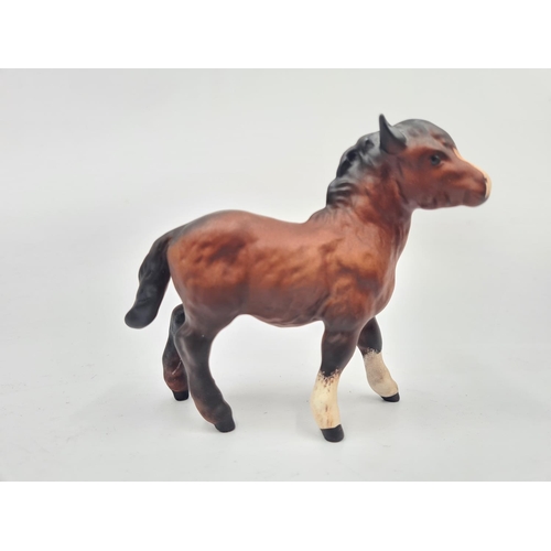 201 - Three Beswick figurines, two foals and one Shetland pony - largest approx. 12cm high