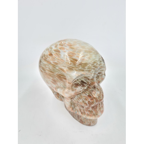 212 - A mottled studio glass skull ornament - approx. 17cm high