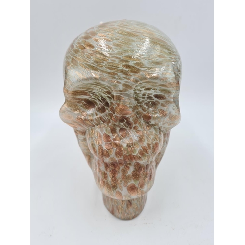 212 - A mottled studio glass skull ornament - approx. 17cm high