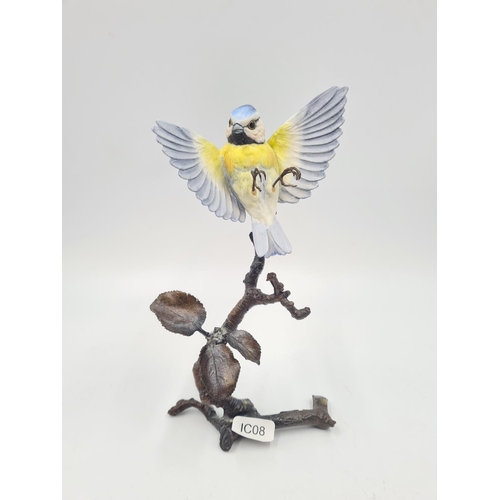 244 - Four ceramic figurines to include Albany Worcester blue tit on bronze branch - approx. 20cm high, Ro... 