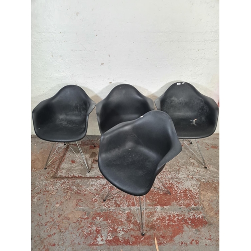 10 - Four Eames style black plastic dining chairs