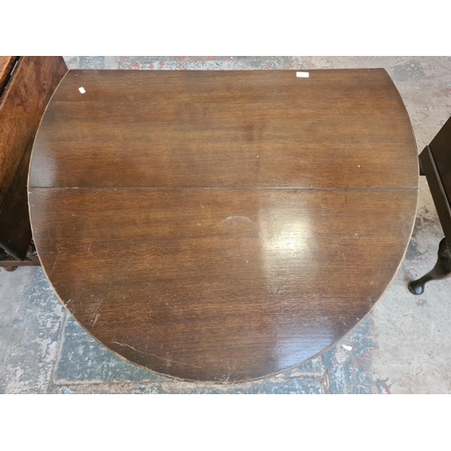 12 - A mid 20th century oak drop leaf gate leg dining table