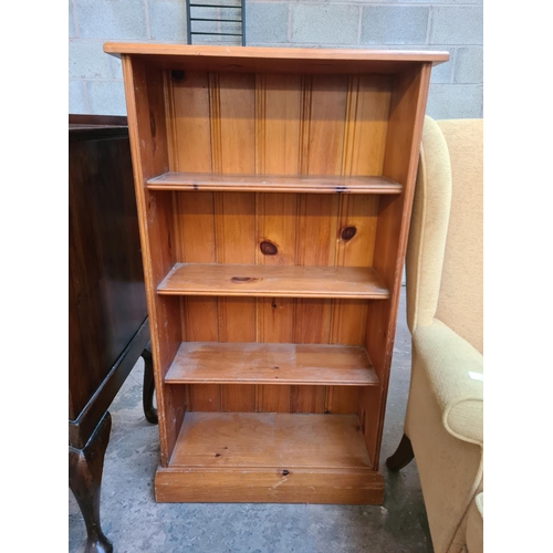 15 - A modern pine four tier bookcase - approx. 107cm high x 61cm wide x 25cm deep