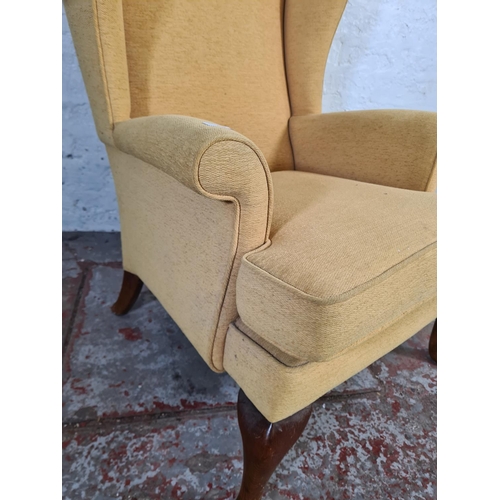 16 - A Victorian style yellow upholstered wing back armchair on cabriole supports - approx. 97cm high x 7... 