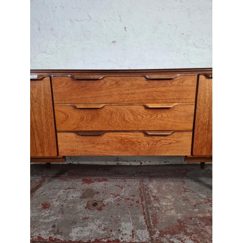 17 - A mid 20th century teak sideboard with three central drawers and two outer cupboard doors - approx. ... 