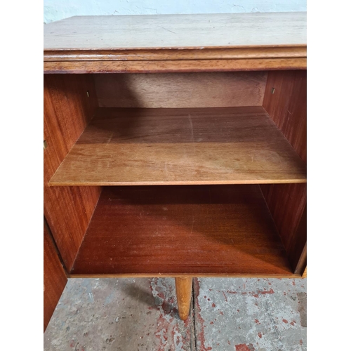 17 - A mid 20th century teak sideboard with three central drawers and two outer cupboard doors - approx. ... 