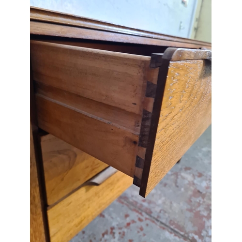 17 - A mid 20th century teak sideboard with three central drawers and two outer cupboard doors - approx. ... 