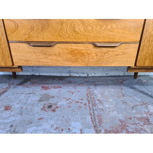 17 - A mid 20th century teak sideboard with three central drawers and two outer cupboard doors - approx. ... 