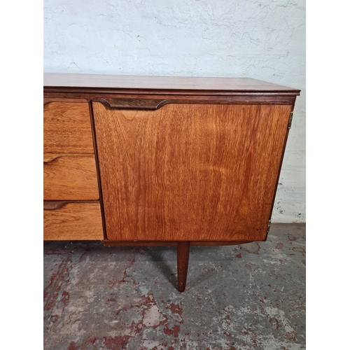 17 - A mid 20th century teak sideboard with three central drawers and two outer cupboard doors - approx. ... 