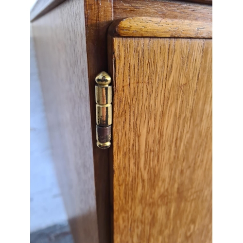 17 - A mid 20th century teak sideboard with three central drawers and two outer cupboard doors - approx. ... 