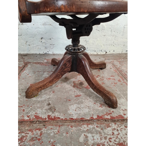 22 - A 1930s oak swivel office desk chair