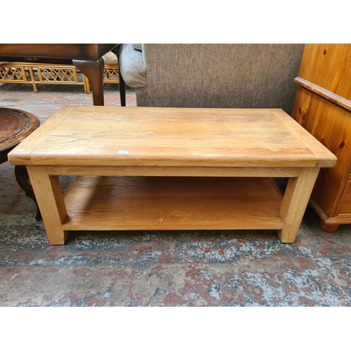 25 - A modern solid oak rectangular two tier coffee table - approx. 45cm high x 54cm wide x 110cm long