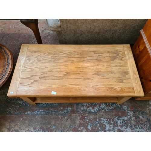 25 - A modern solid oak rectangular two tier coffee table - approx. 45cm high x 54cm wide x 110cm long