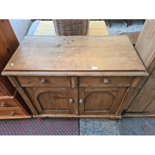 28 - A Victorian style solid pine sideboard with two drawers and two cupboard doors - approx. 96cm high x... 