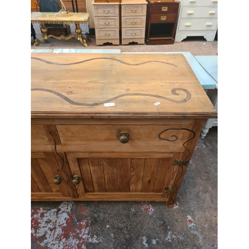 33 - A modern solid pine sideboard with two drawers and two cupboard doors - approx. 77cm high x 123cm wi... 