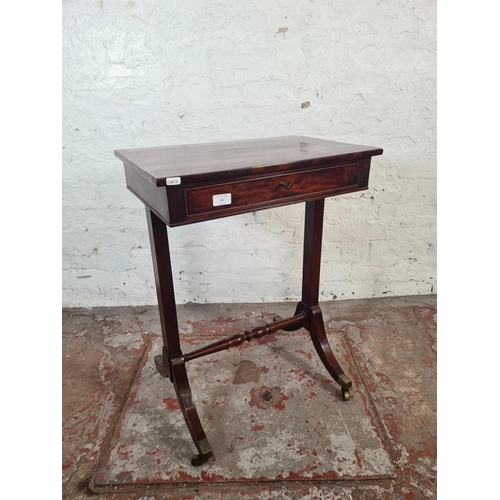 35 - A Regency mahogany rectangular side table with single drawer, lower stretcher and four brass castors... 