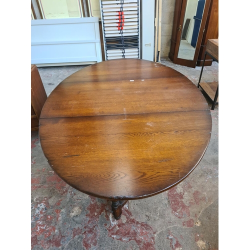 36 - A 17th century style solid oak drop leaf gate leg dining table - approx. 74cm high x 137cm wide x 20... 