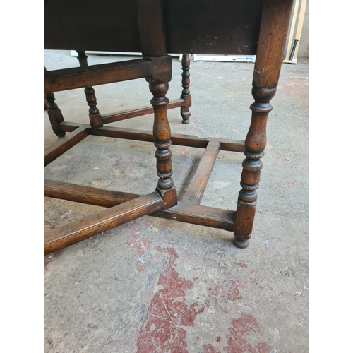 36 - A 17th century style solid oak drop leaf gate leg dining table - approx. 74cm high x 137cm wide x 20... 