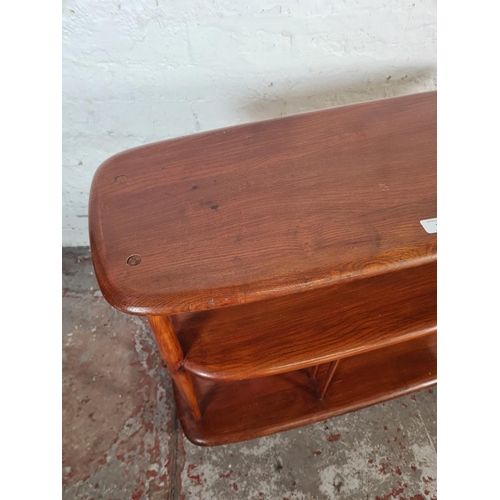 38 - A mid 20th century Ercol elm and beech three tier trolley on castors - approx. 71cm high x 90cm wide... 