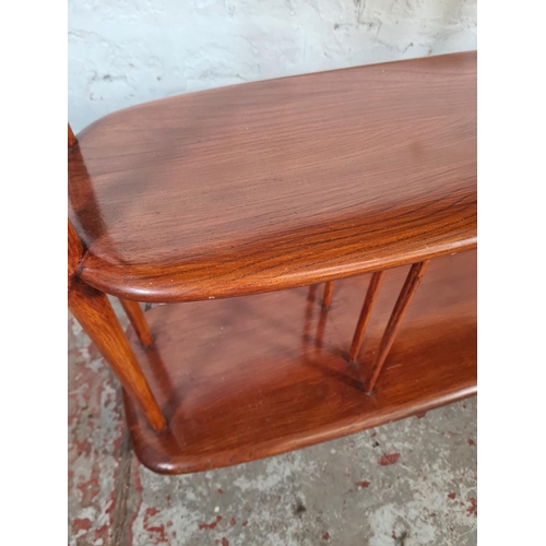 38 - A mid 20th century Ercol elm and beech three tier trolley on castors - approx. 71cm high x 90cm wide... 