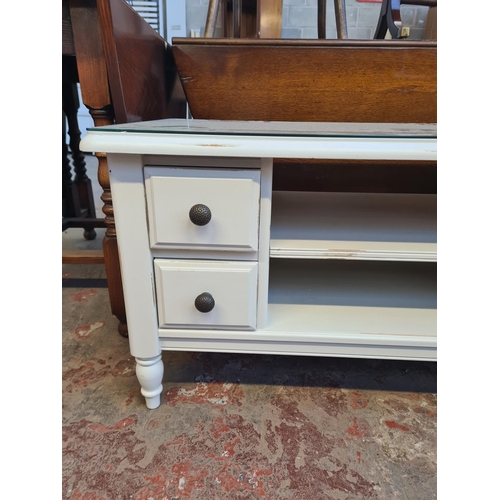 39 - A modern grey painted rectangular coffee table with four drawers and glass top - approx. 53cm high x... 