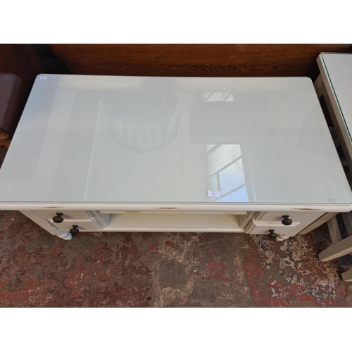 39 - A modern grey painted rectangular coffee table with four drawers and glass top - approx. 53cm high x... 