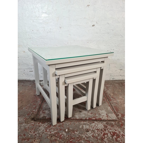 40 - A modern grey painted nest of three tables - approx. 56cm high x 60cm square