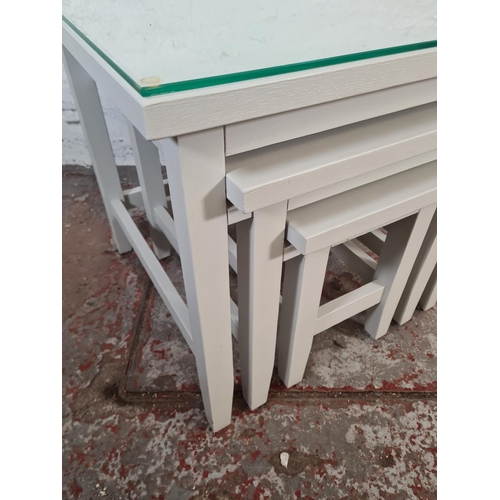 40 - A modern grey painted nest of three tables - approx. 56cm high x 60cm square