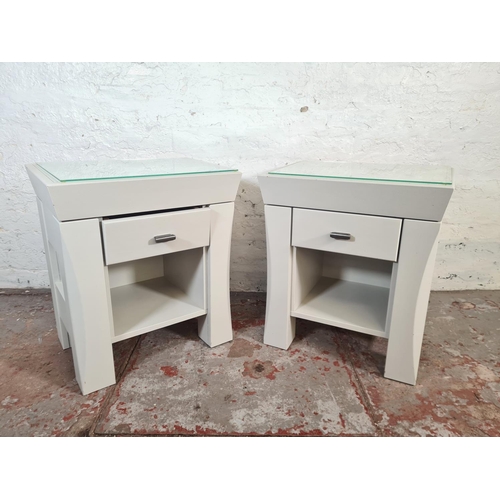 41 - A pair of modern grey painted bedside tables with glass tops and single drawer - approx. 60cm high x... 