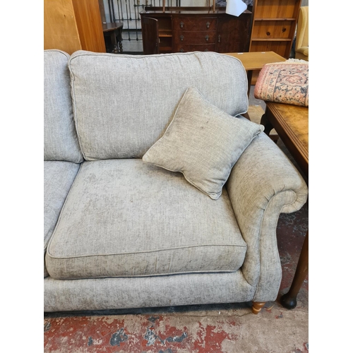 48 - A Parker Knoll grey fabric upholstered three seater sofa