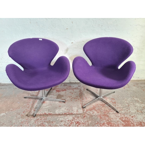 51 - A pair of modern Arne Jacobsen style purple fabric upholstered and steel swivel swan chairs