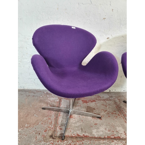 51 - A pair of modern Arne Jacobsen style purple fabric upholstered and steel swivel swan chairs