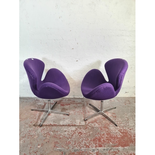 51 - A pair of modern Arne Jacobsen style purple fabric upholstered and steel swivel swan chairs