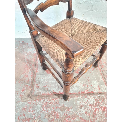 54A - A 19th century style beech and elm rushed seated carver dining chair