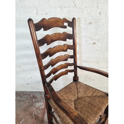 54A - A 19th century style beech and elm rushed seated carver dining chair