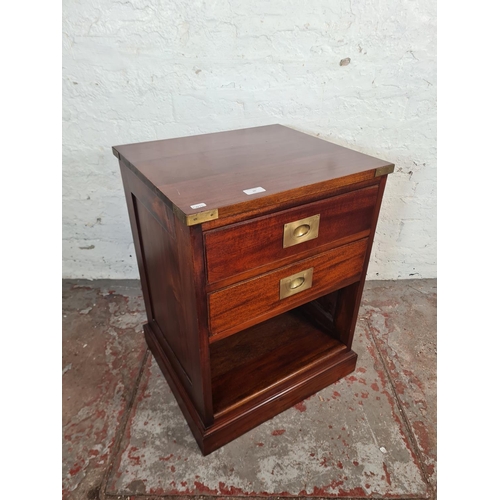 60 - A mahogany and brass campaign style two drawer bedside cabinet