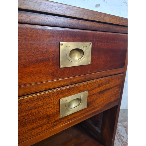 60 - A mahogany and brass campaign style two drawer bedside cabinet