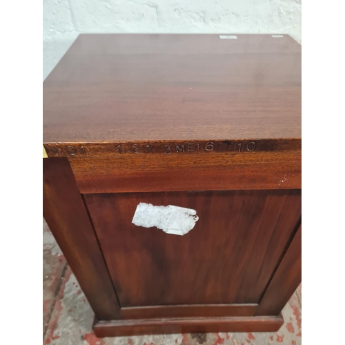 60 - A mahogany and brass campaign style two drawer bedside cabinet