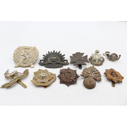 1159E - A collection of vintage military cap badges to include London, Scottish, K.R.R.C etc.