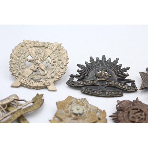 1159E - A collection of vintage military cap badges to include London, Scottish, K.R.R.C etc.