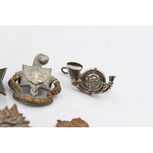 1159E - A collection of vintage military cap badges to include London, Scottish, K.R.R.C etc.