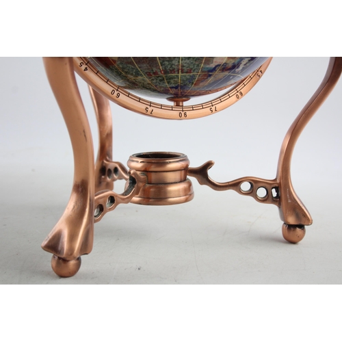 495 - A polished hardstone terrestrial world globe on copper stand