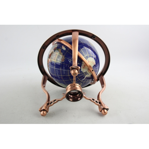 495 - A polished hardstone terrestrial world globe on copper stand