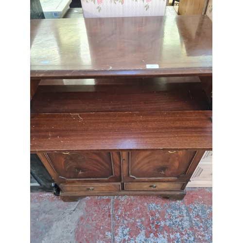 101 - A Regency style mahogany media cabinet with fall front and two cupboard doors