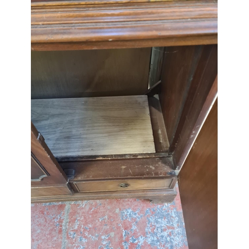 101 - A Regency style mahogany media cabinet with fall front and two cupboard doors