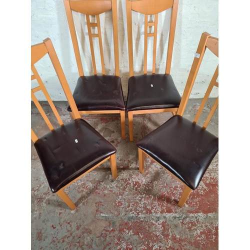 105 - Four modern beech and black leatherette dining chairs