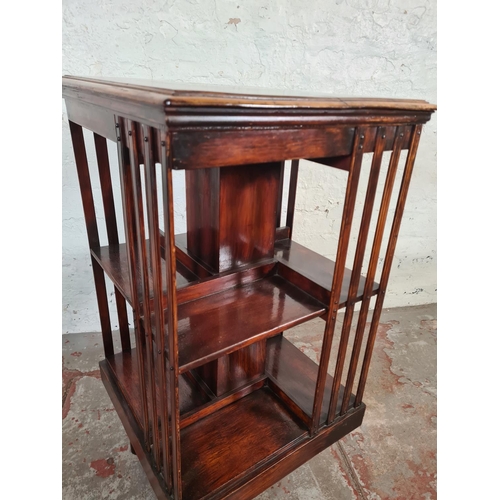 110 - An early 20th century mahogany revolving bookcase - approx. 84cm high x 46cm squared